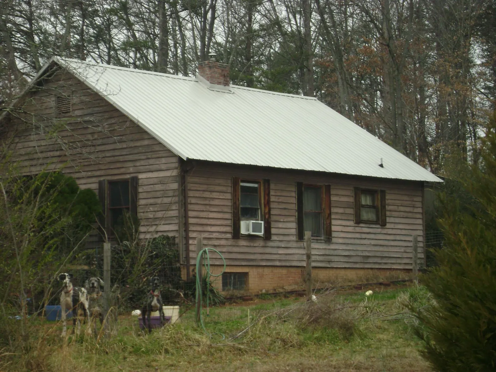 White metal roof on an old wood sided farmhouse, from a Metal Roof Installation job in Mc Connellsburg
